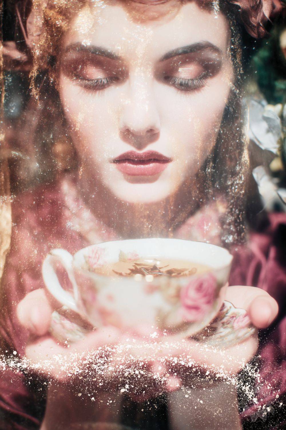 fortune teller looking at tea leaves in a tea cup